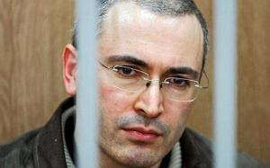 Mikhail Khodorkovsky...** FILE ** In this June 16, 2004 file photo, former Yukos oil company CEO Mikhail Khodorkovsky seen behind bars at a courtroom, at the start of a trial in Moscow. From a tiny cell in one of Moscow's most notorious prisons, Mikhail Khodorkovsky, the man who was once his country's wealthiest tycoon awaits a trial that for many will be a critical test of Russian justice, and President Dmitry Medvedev's commitment to the rule of law. Beginning Tuesday, March 3, 2009, Khodorkovsky will once again peer out from a courtroom cage and stand trial for alleged financial crimes related to the oil company that he turned into Russia's largest. (AP Photo/Teodor Kustov, File)
